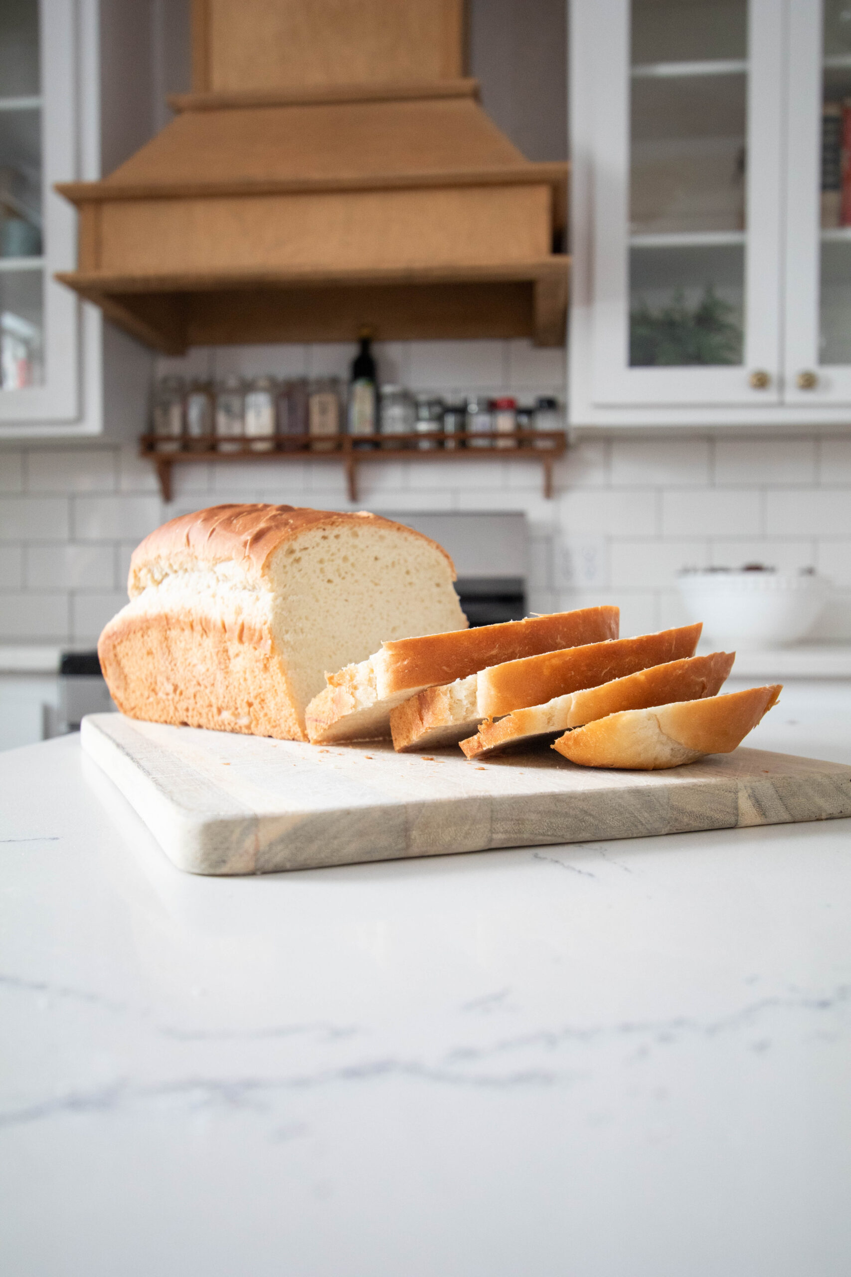 sliced homemade sandwich bread on a wooden cutting board