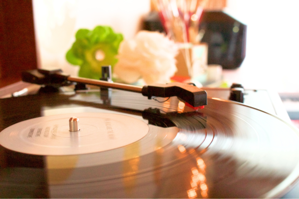 close up of record player with floral decor in background with cozy spring ambience