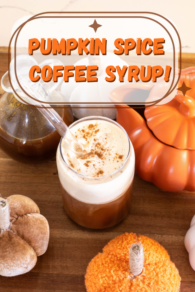 Pumpkin Spice iced latte on a wooden tray next to a glass jar of homemade pumpkin spice coffee syrup surrounded by fall decor with a text overlay that reads "Pumpkin Spice Coffee Syrup!"