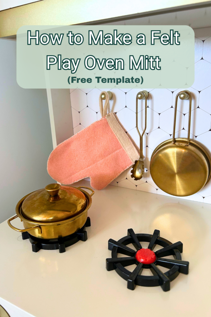 Play felt oven mitt hanging on a white and gold play kitchen with text overlay that reads How To Make a Felt Play Oven Mitt (free template)